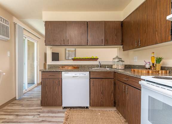 Model Kitchen with wood cabinetry and white appliances