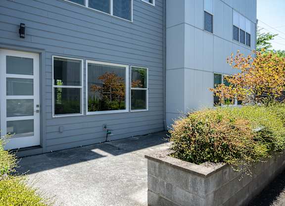 A grey house with a white door and windows.