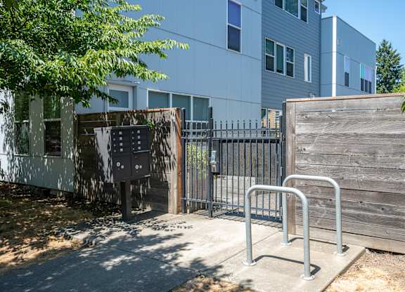 A metal gate blocks the entrance to a building.