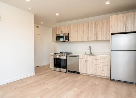 A kitchen with wooden cabinets and stainless steel appliances.
