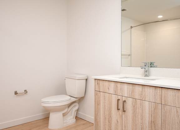A white toilet sits next to a bathroom sink.