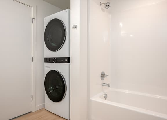 A white washing machine and dryer in a small laundry room.