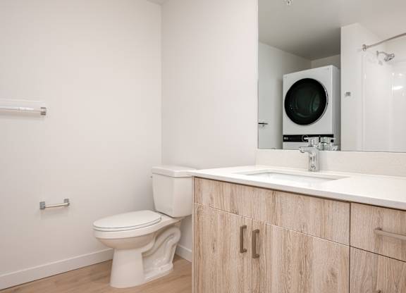 A white toilet sits next to a sink in a bathroom.