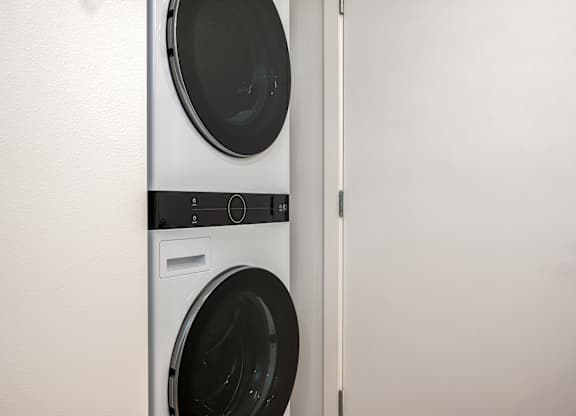 A white washing machine and dryer in a laundry room.