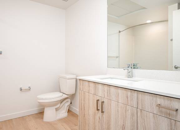 A white toilet sits next to a sink in a bathroom.