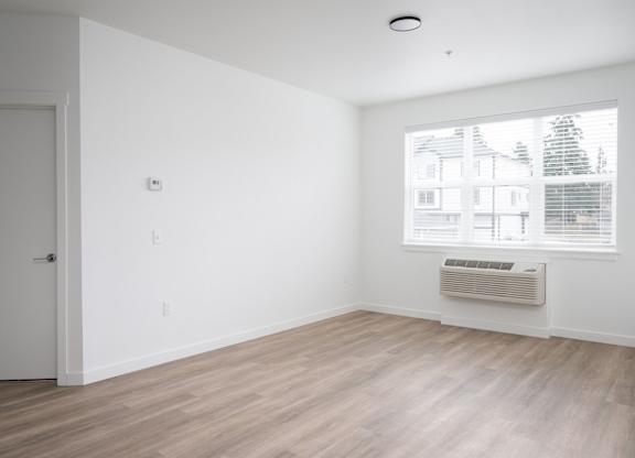 A room with a window and a door.