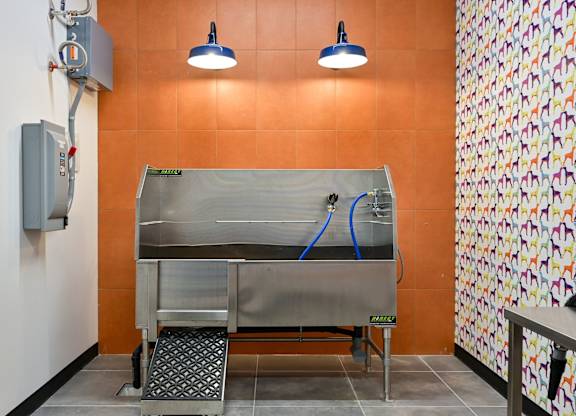 A wall-mounted oven with a stainless steel finish is installed in a kitchen.