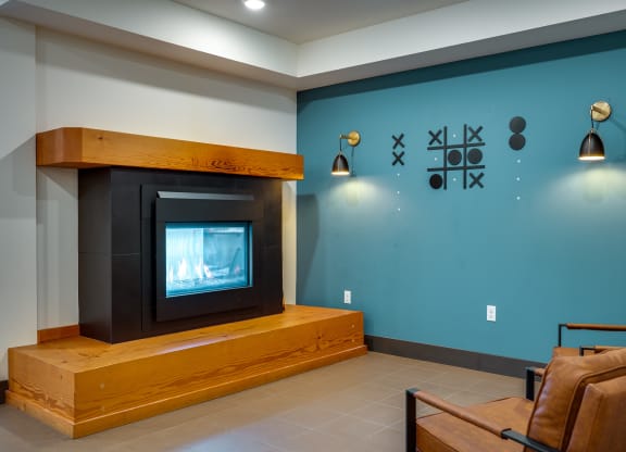 a living room with a fireplace and a blue wall