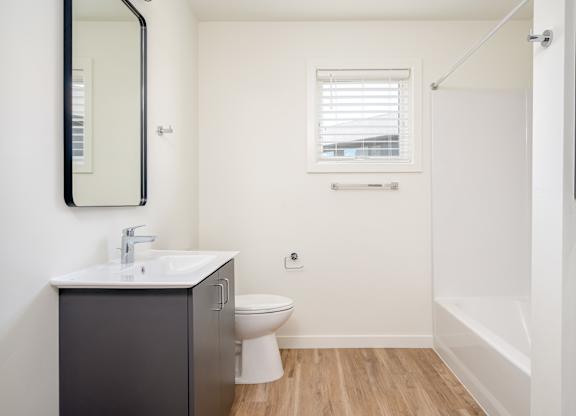 A bathroom with a sink, toilet, and bathtub.
