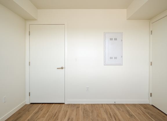 A white door is on the left and a white framed door is on the right.