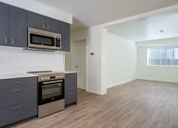 A kitchen with a stove top oven and microwave above it.
