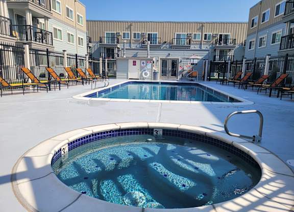 Sunset Apartments | Outdoor Seasonal Pool + Hot Tub