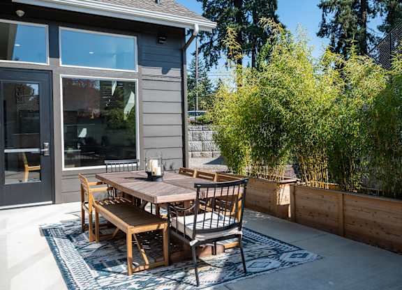 A table with chairs is on a patio.