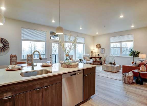 A modern kitchen with wooden cabinets and a large island.