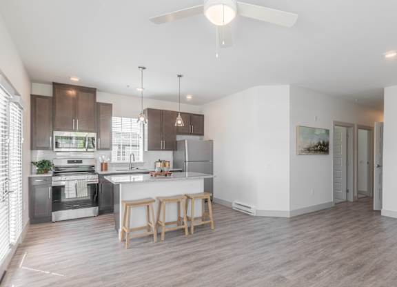 A modern kitchen with a dining table and chairs.