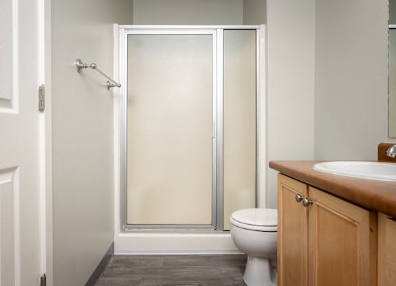 A white toilet sits next to a sink in a bathroom.