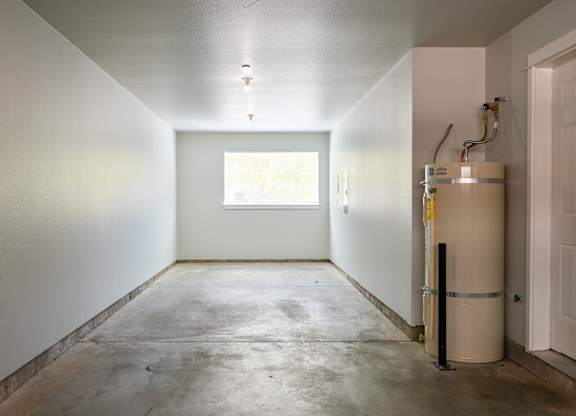 A room with a window and a white door.