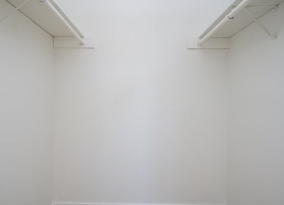 A white wall with two white bars on top.