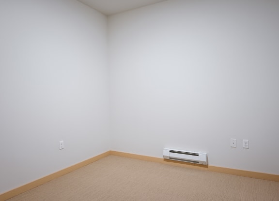 bedroom with a heater and carpet