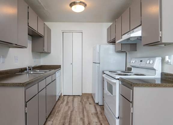 Sedona | One Bedroom Kitchen with plank style flooring and white appliances