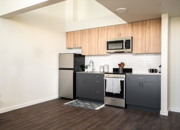 kitchen with stainless steel appliances and two-tone wood cabinetry