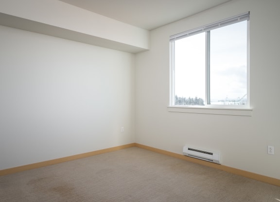 bedroom with large window and carpet