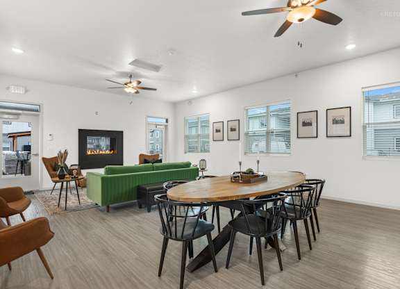 A living room with a fireplace, a couch, a chair, and a dining table.