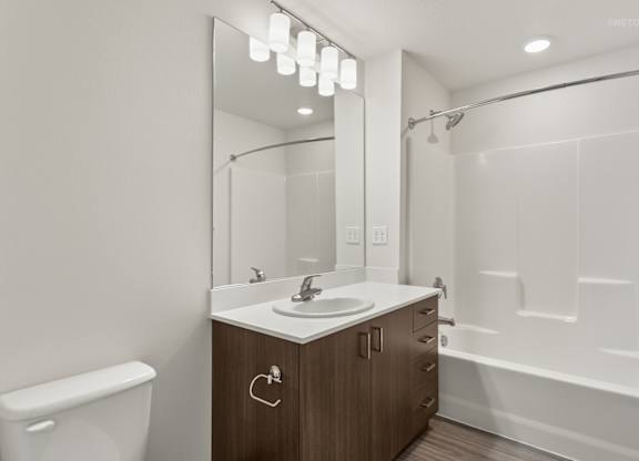 A modern bathroom with a white sink and a mirror above it.
