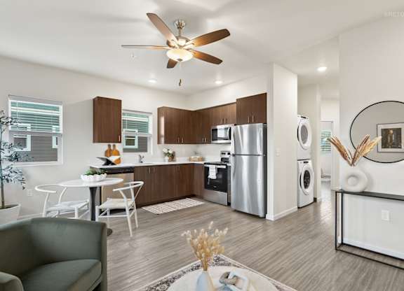 A modern kitchen with a dining table and chairs.