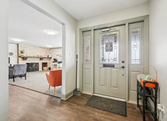 A room with a grey door and a grey couch.