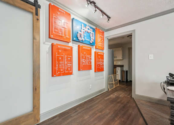 A hallway with orange posters on the wall.