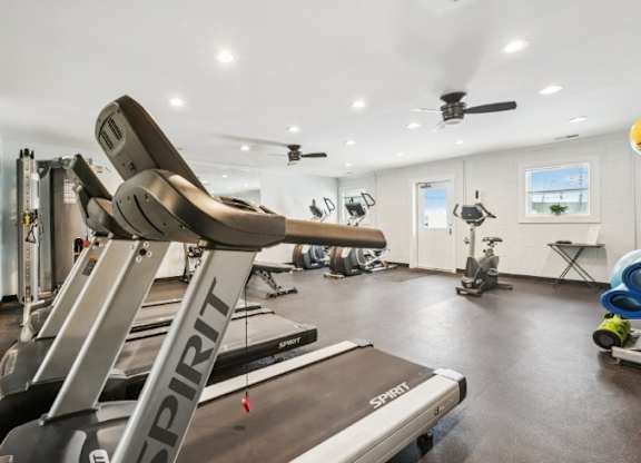 A gym with a treadmill and other exercise equipment.