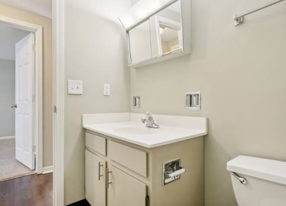 A bathroom with a white sink and a white tub.