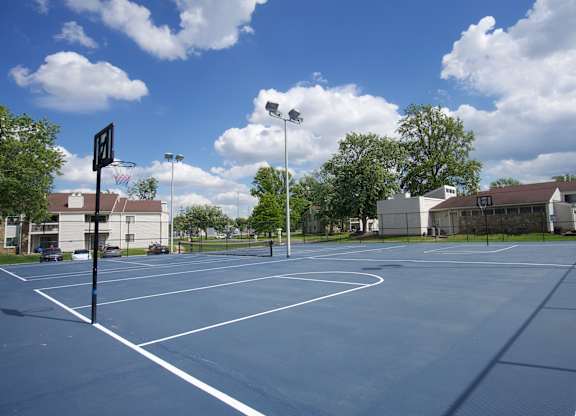 A basketball court with a basketball hoop and a sign on the side.