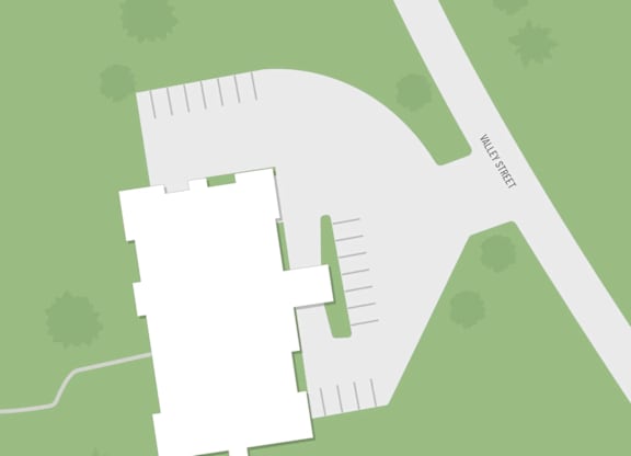 A white building is situated on a green field.