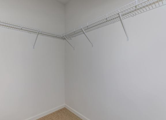 A white wall with a metal rack on it.