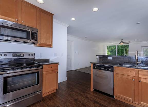 A kitchen with wooden cabinets and stainless steel appliances.