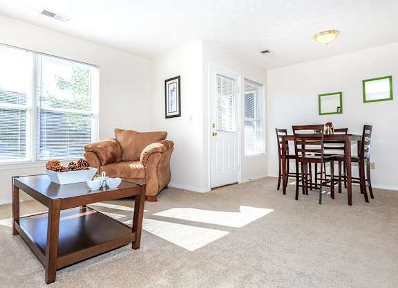 A living room with a brown chair and a coffee table.