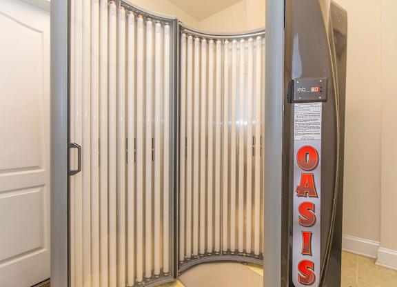 A room with a white door and a wall with a sign that says Oasis.