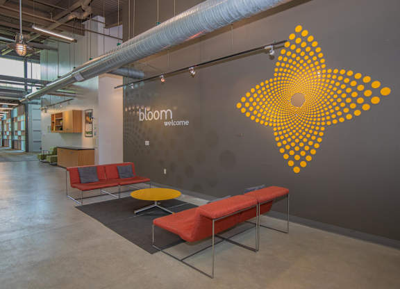 A bloom welcome sign on a wall in a modern office.