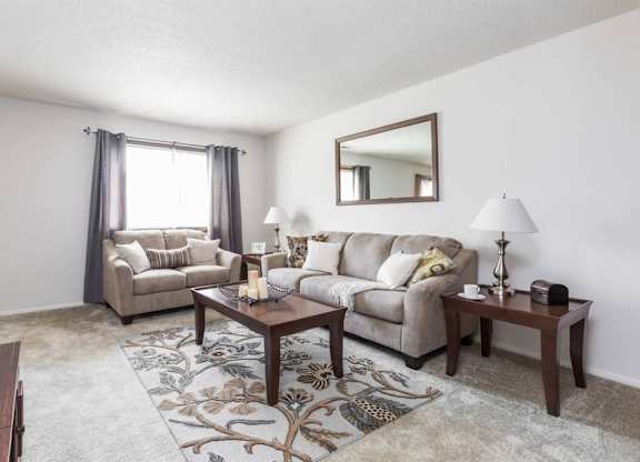A living room with a couch, chair, and coffee table.