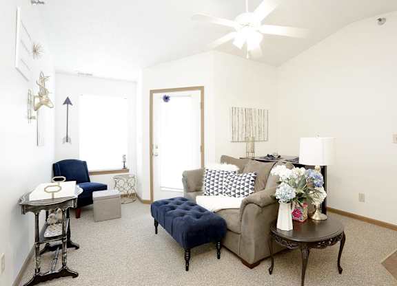 A living room with a blue couch and a coffee table.