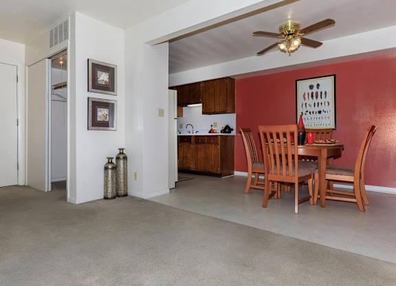 A living room with a dining table and chairs.