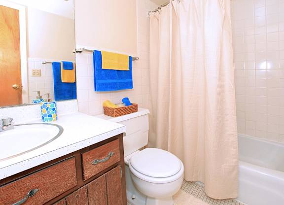 A white toilet sits next to a sink in a bathroom.