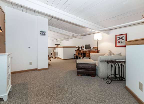 A living room with a couch, chair, and a table.