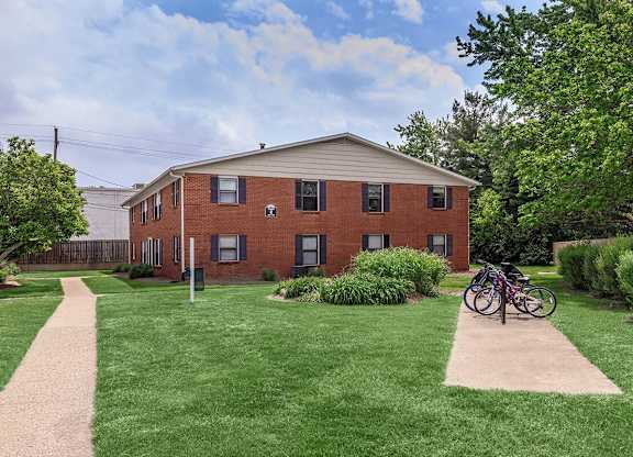 A red brick building with a bicycle parked in front.