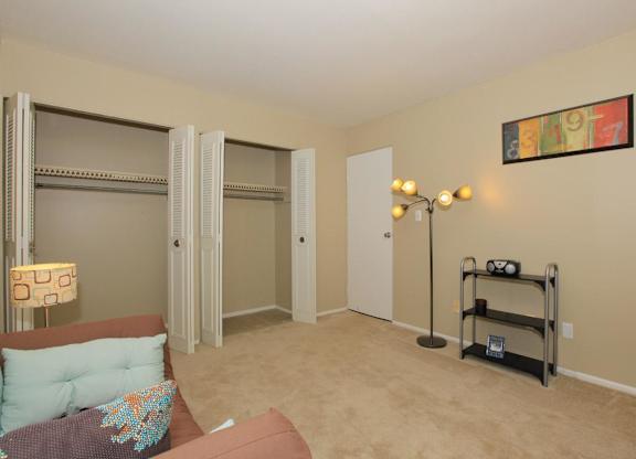 A living room with a couch, a chair, a lamp, and a picture on the wall.