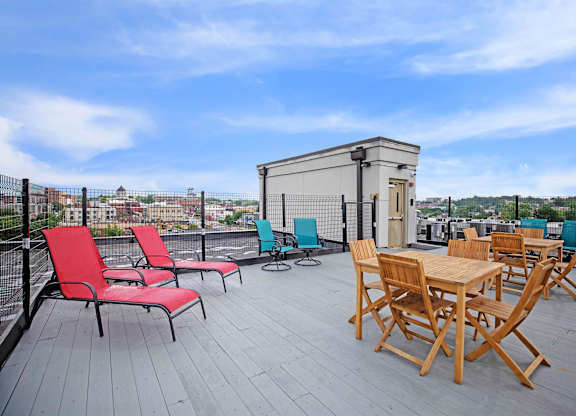 A wooden table and chairs are set up on a wooden deck.