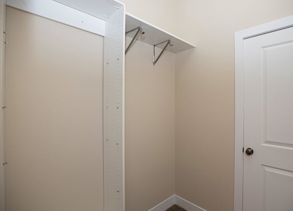 A white door is on the right and a white shelf is on the left.