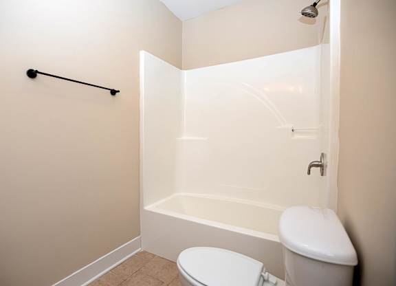 A white toilet and sink in a small bathroom.